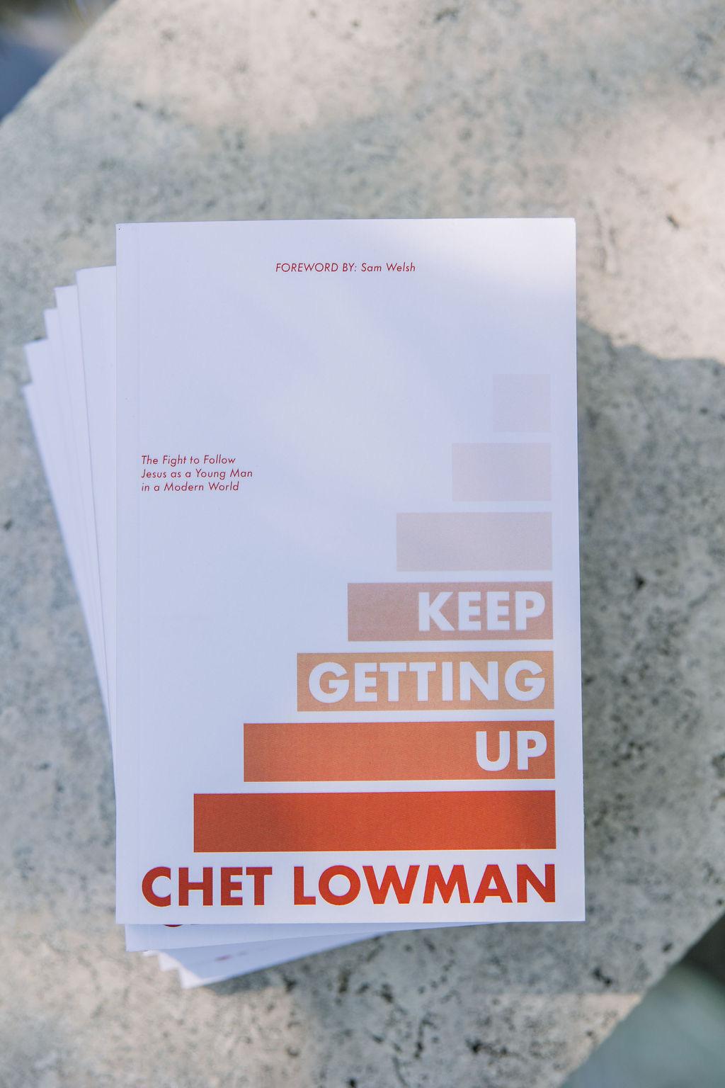 Chet Lowman with a copy of Keep Getting Up